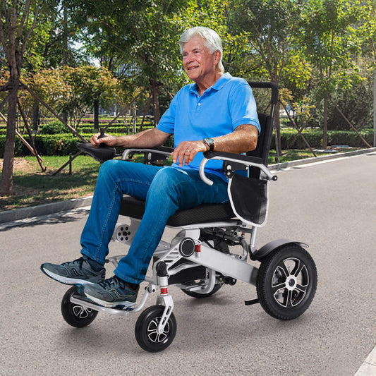 An elderly man is driving our electric wheelchair on the road.